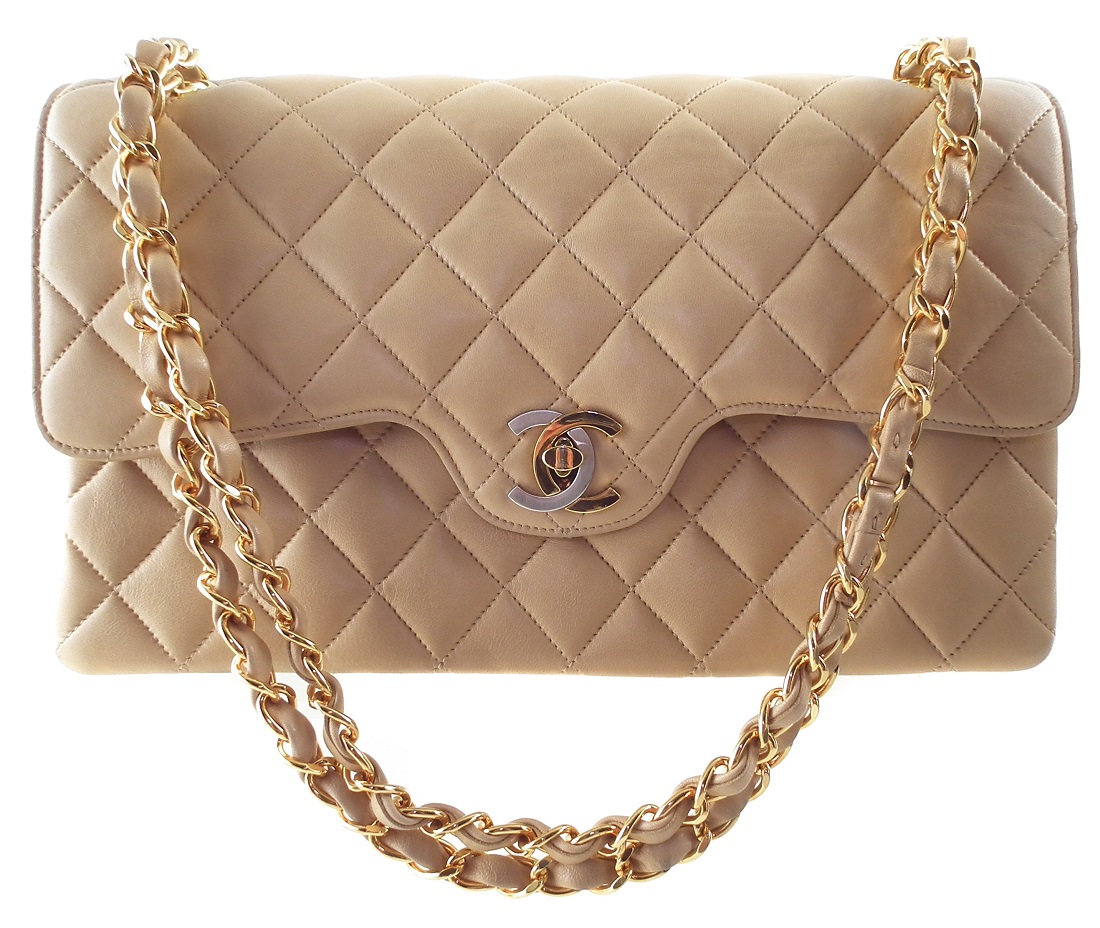 A rare Chanel medium double flap handbag, circa 1991-4, the beige quilted lambskin leather exterior with gold and silver-tone locking clasp, gold-tone double chain shoulder strap, serial number 2827451. Dimensions 26 x 16 x 7cm. With maker's authenticity card.  26 x 16 x 7cm  Sold for £2,196